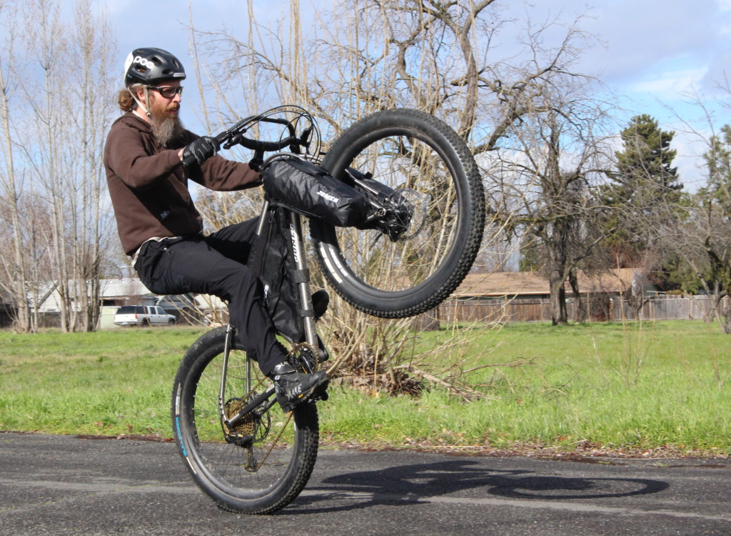 Yes you will still be able to wheelie your bike while using Truss Fork Packs.